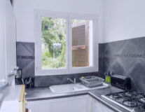 a kitchen with a stove top oven sitting next to a window